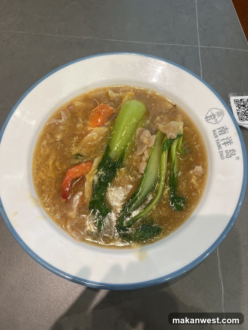 Bowl of soup with vegetables and shrimp