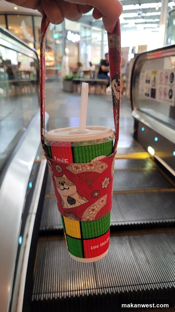 Handheld Cup on Escalator