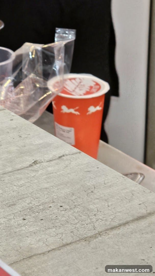 Orange Cup on Concrete Surface