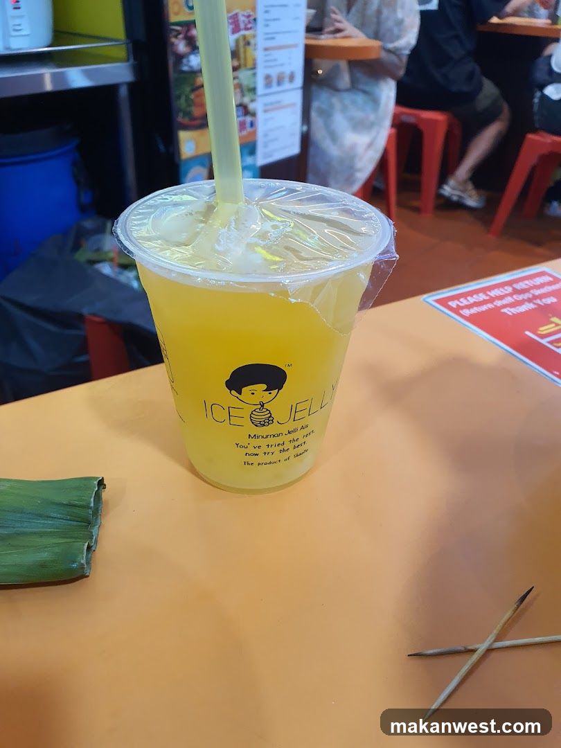 Yellow drink in plastic cup with straw