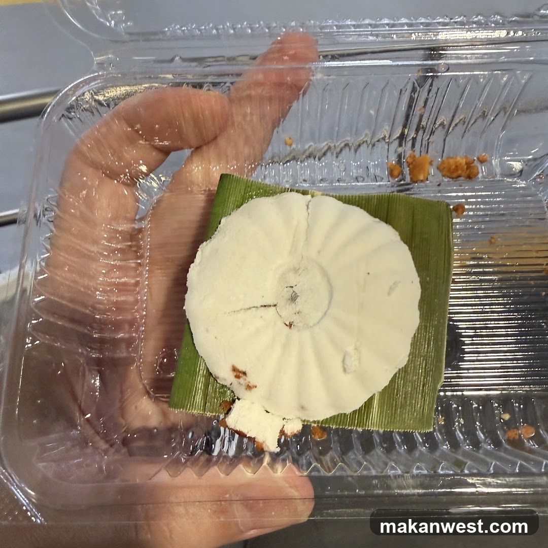 White dessert on a banana leaf in a plastic container