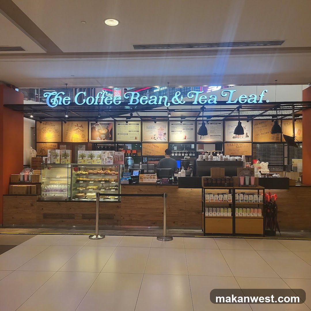 A coffee shop with a prominent neon sign that reads "The Coffee Bean & Tea Leaf." The storefront features a display case filled with pastries and cakes, a counter with coffee machines, and shelves stocked with coffee beans and merchandise. Several menu boards are visible above the counter, displaying various drinks and food items.