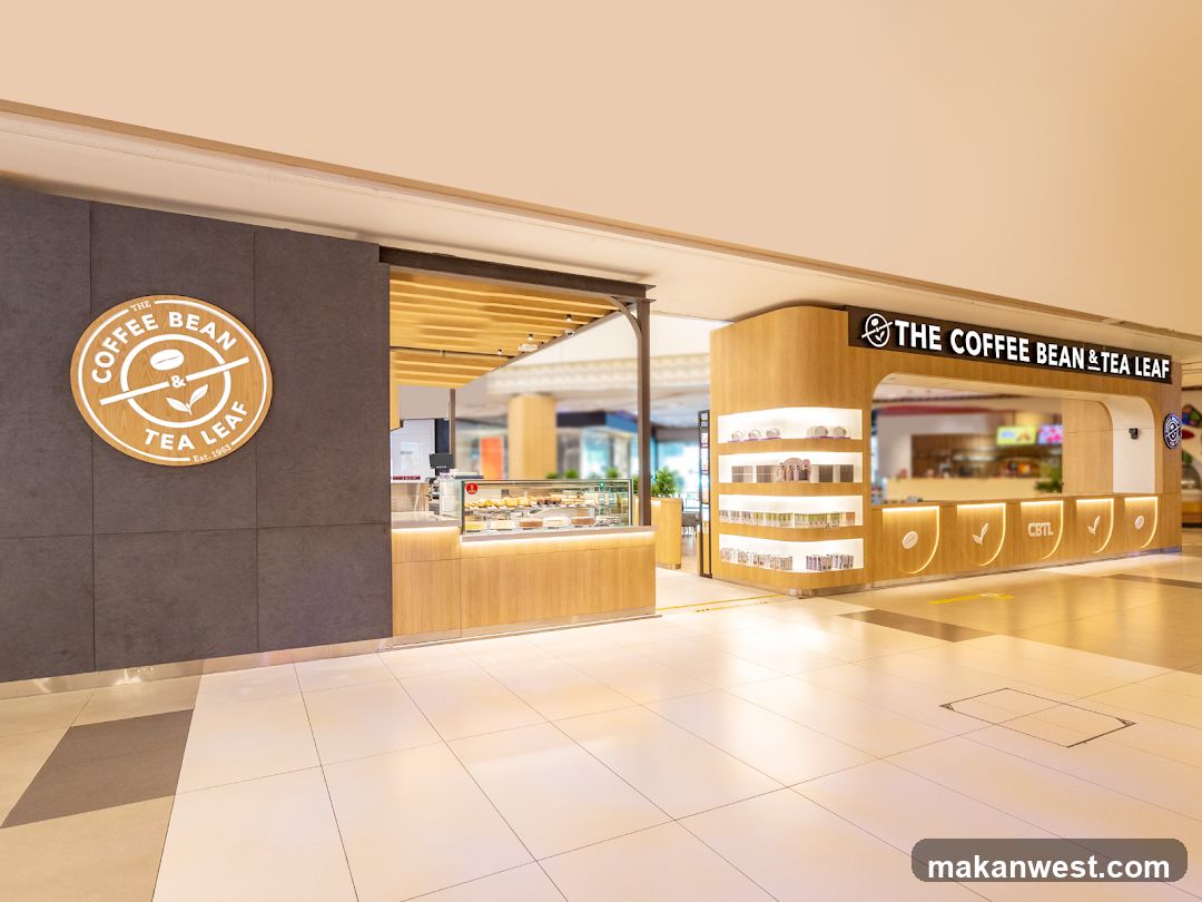 A modern coffee shop with a wooden facade and a prominent circular logo on the left. The shop features a display case with pastries and a counter area with illuminated branding.