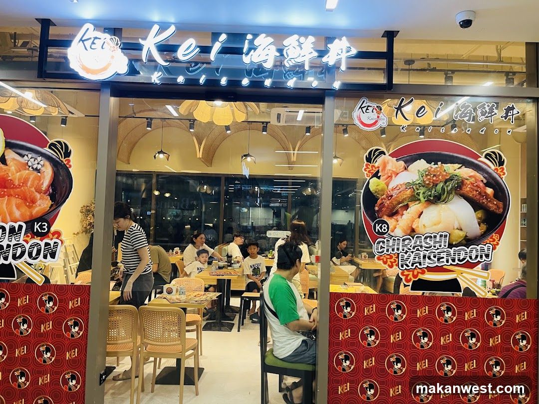 The exterior of a Japanese restaurant with a prominent sign reading "Kei Kaisendon". Large posters display images of salmon sashimi and chirashi kaisendon. Inside, customers are seated at tables, and the restaurant appears to have a modern, clean interior with warm lighting.