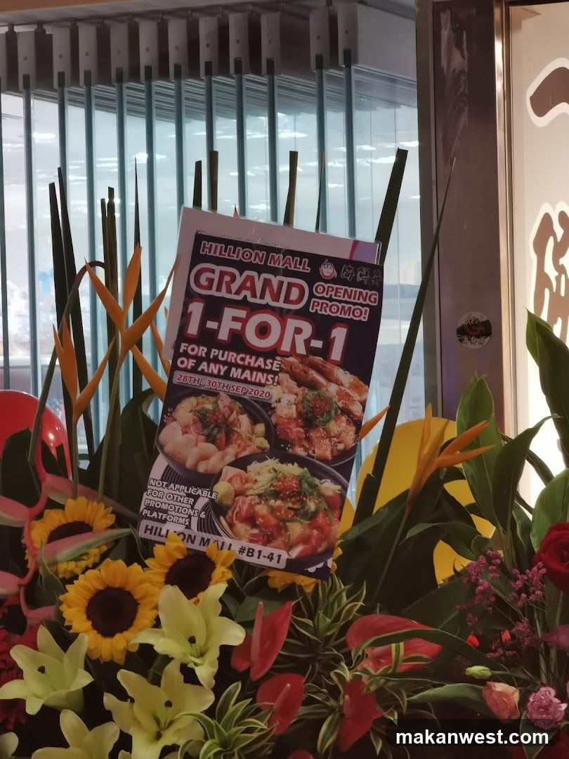 A promotional flyer for a 1-for-1 offer on mains at Hillion Mall, valid from September 28th to 30th, 2020. The flyer features images of seafood dishes. It is placed in a floral arrangement outside a shop.