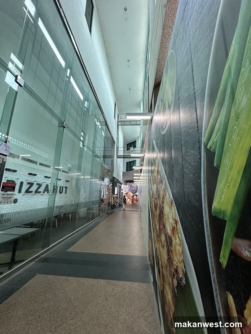 Corridor with storefronts and food murals