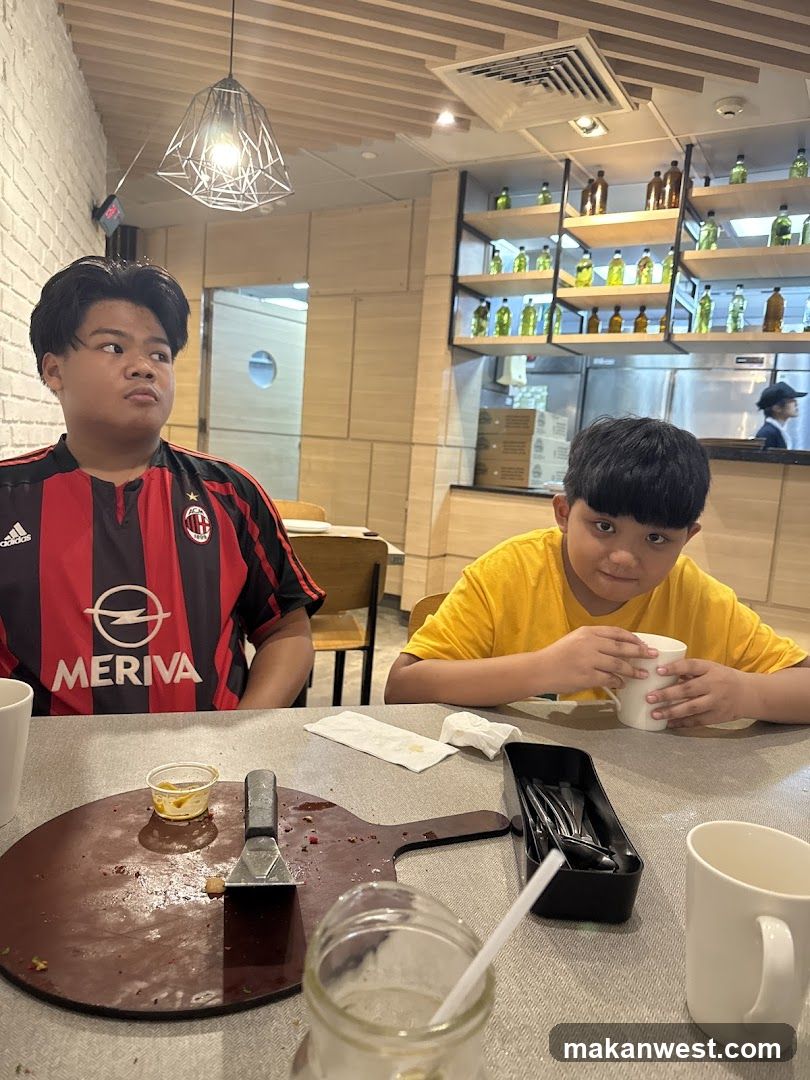 Two boys at a table in a restaurant