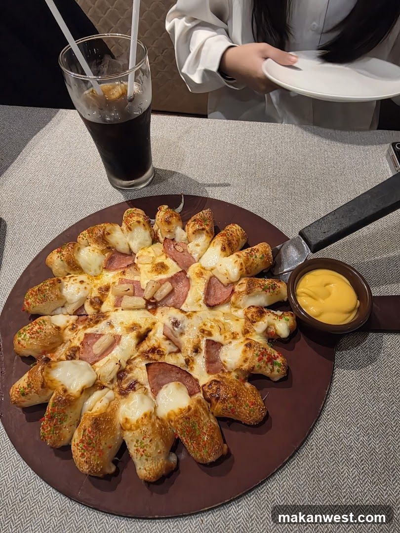 Pizza with stuffed crust and dipping sauce