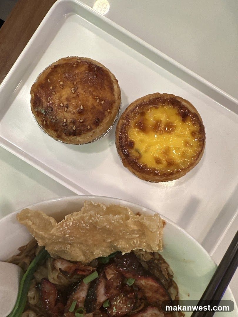 Two pastries and a bowl of noodles