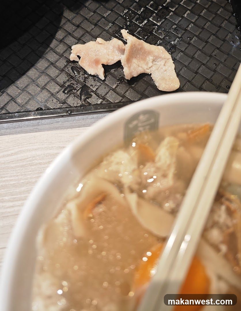 Close-up of a Meal with Sliced Meat and Soup
