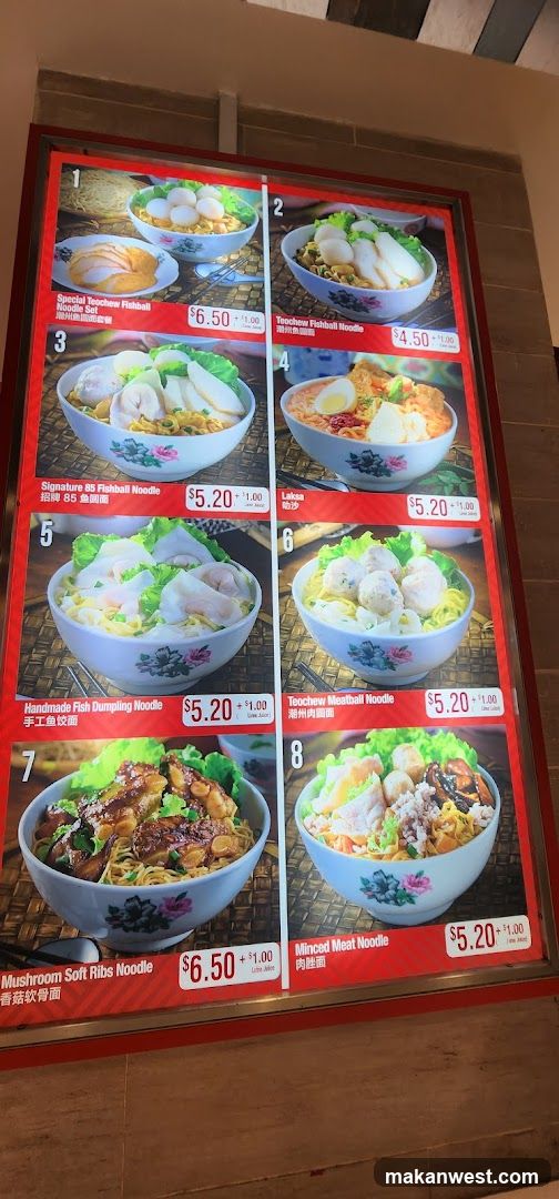 A menu board displaying various noodle dishes with images and prices.