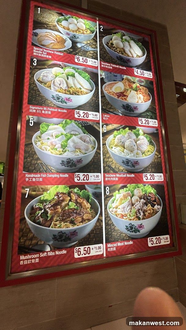 A menu board displaying various noodle dishes with images and prices.
