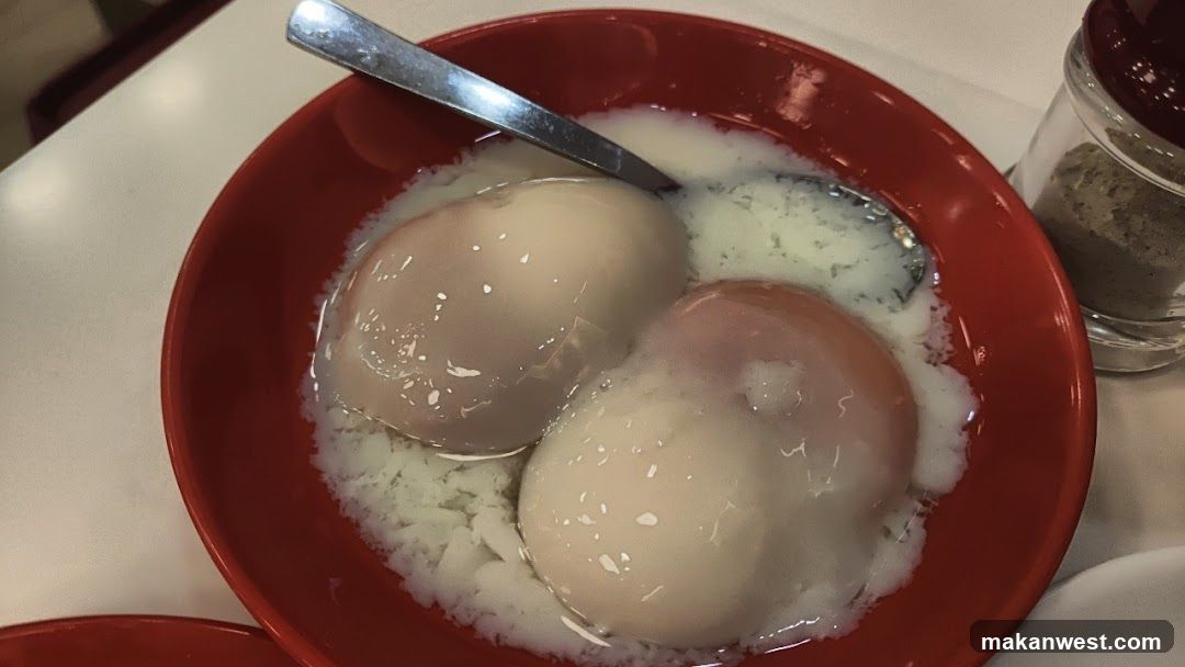 Soft-boiled eggs in a red bowl