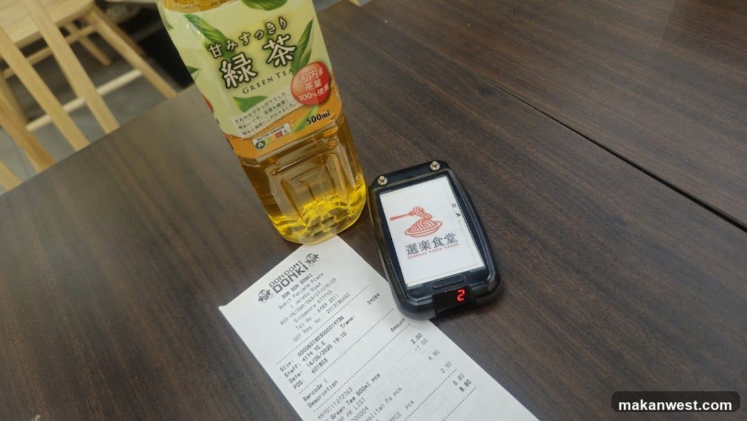 Table with Green Tea, Receipt, and Pager
