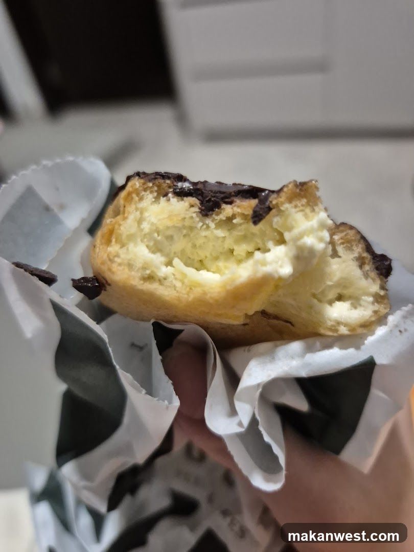 Chocolate-covered pastry with cream filling