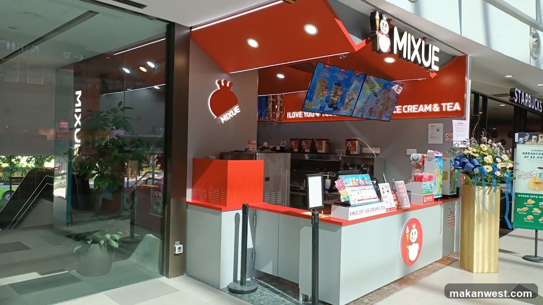 A bright orange and grey storefront for Mixue Ice Cream & Tea is visible, with the brand logo and name prominently displayed. Digital menu boards show colorful drinks and desserts. To the right, a Starbucks storefront is partially visible. The shop has a clean, modern aesthetic with glass windows and interior lighting.