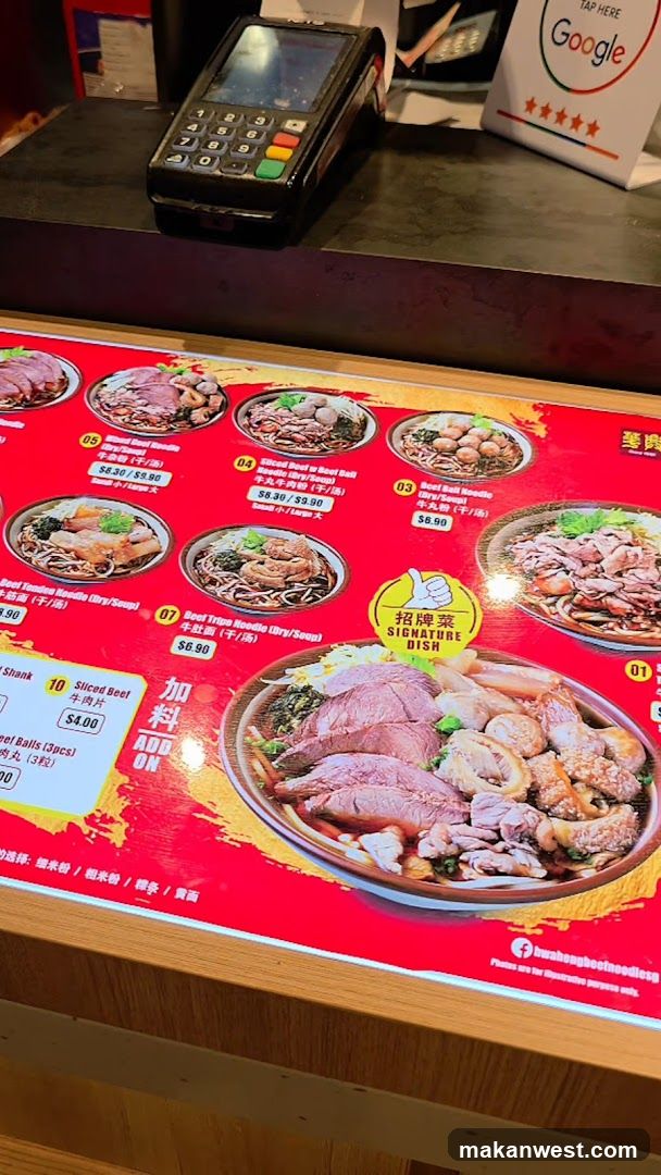 A close-up of a menu board displaying various beef noodle dishes with prices. A payment terminal is visible in the background.