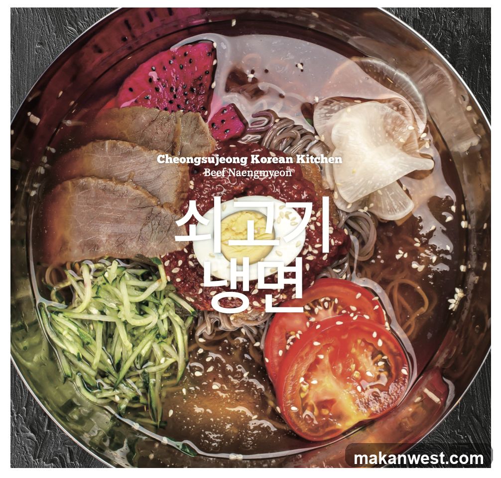 A close-up overhead view of a bowl of Beef Naengmyeon, a Korean cold noodle dish. The dish features thin noodles in a clear broth, topped with slices of beef, shredded cucumber, sliced tomatoes, a hard-boiled egg, and pieces of dragon fruit. The bowl is a metallic silver, and the background is a dark, textured surface. Text overlays the dish, reading "Cheongsujeong Korean Kitchen" and "Beef Naengmyeon" in English, and "쇠고기 냉면" in Korean.