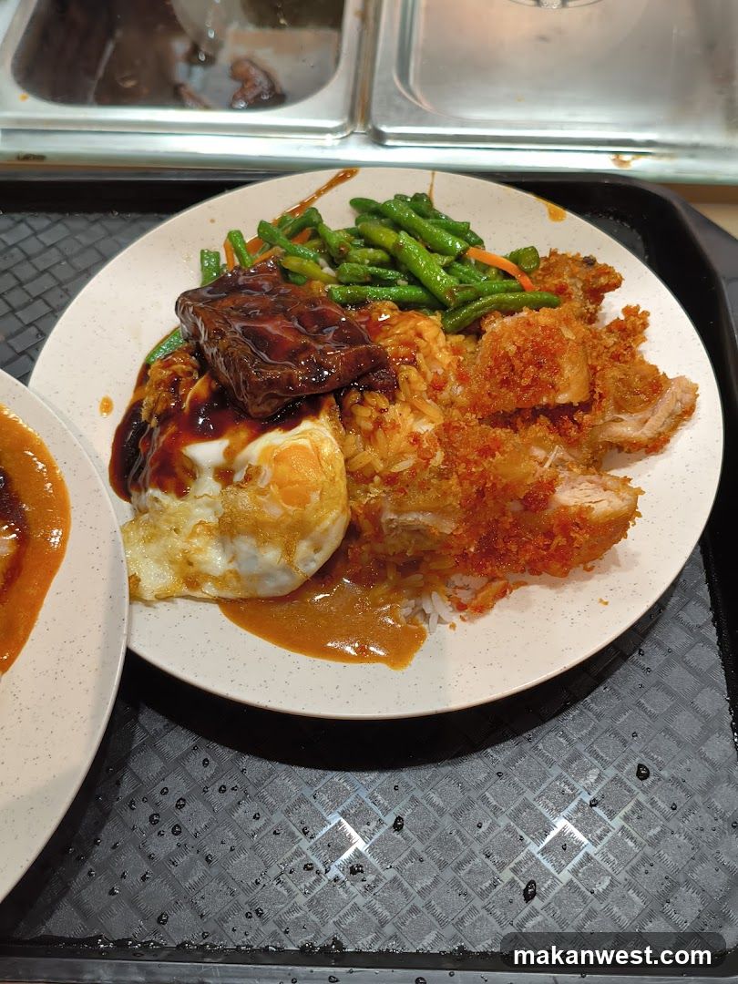 Rice plate with fried chicken, egg, and vegetables