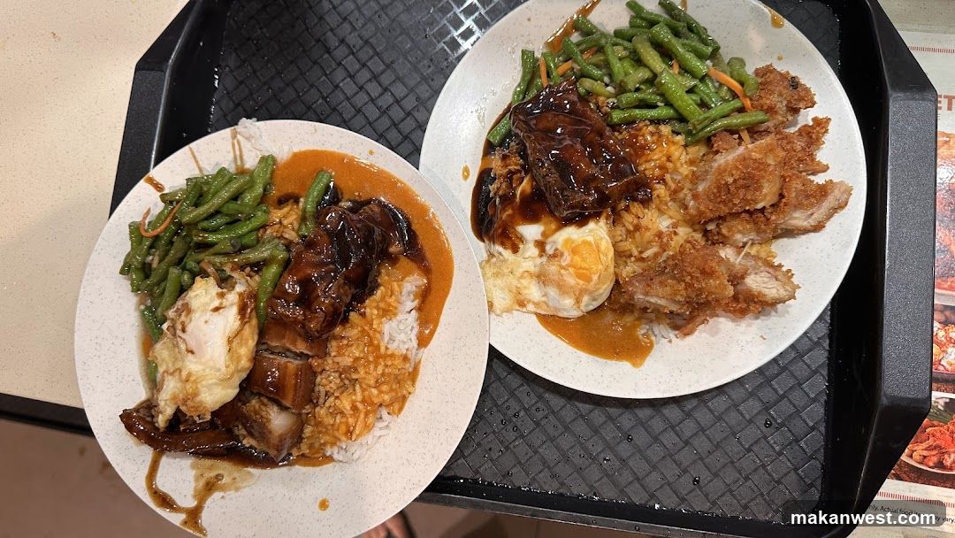 Two plates of rice with meat and vegetables