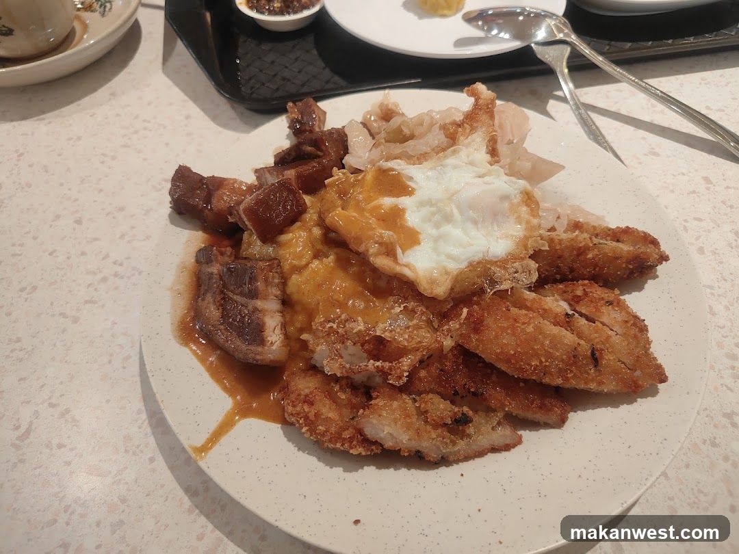 Plate of food with fried items and meat