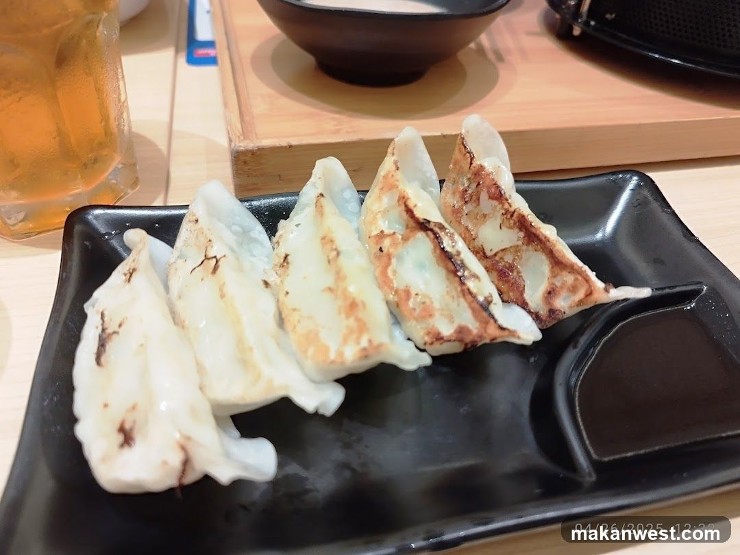 Pan-fried dumplings with dipping sauce