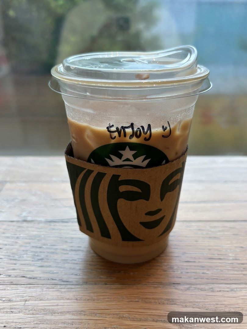 Iced Coffee with "Enjoy :)" written on cup