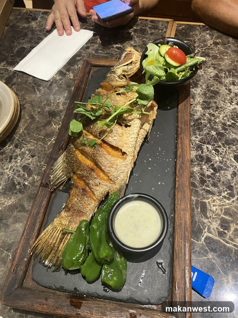 Whole Fried Fish with Salad and Peppers