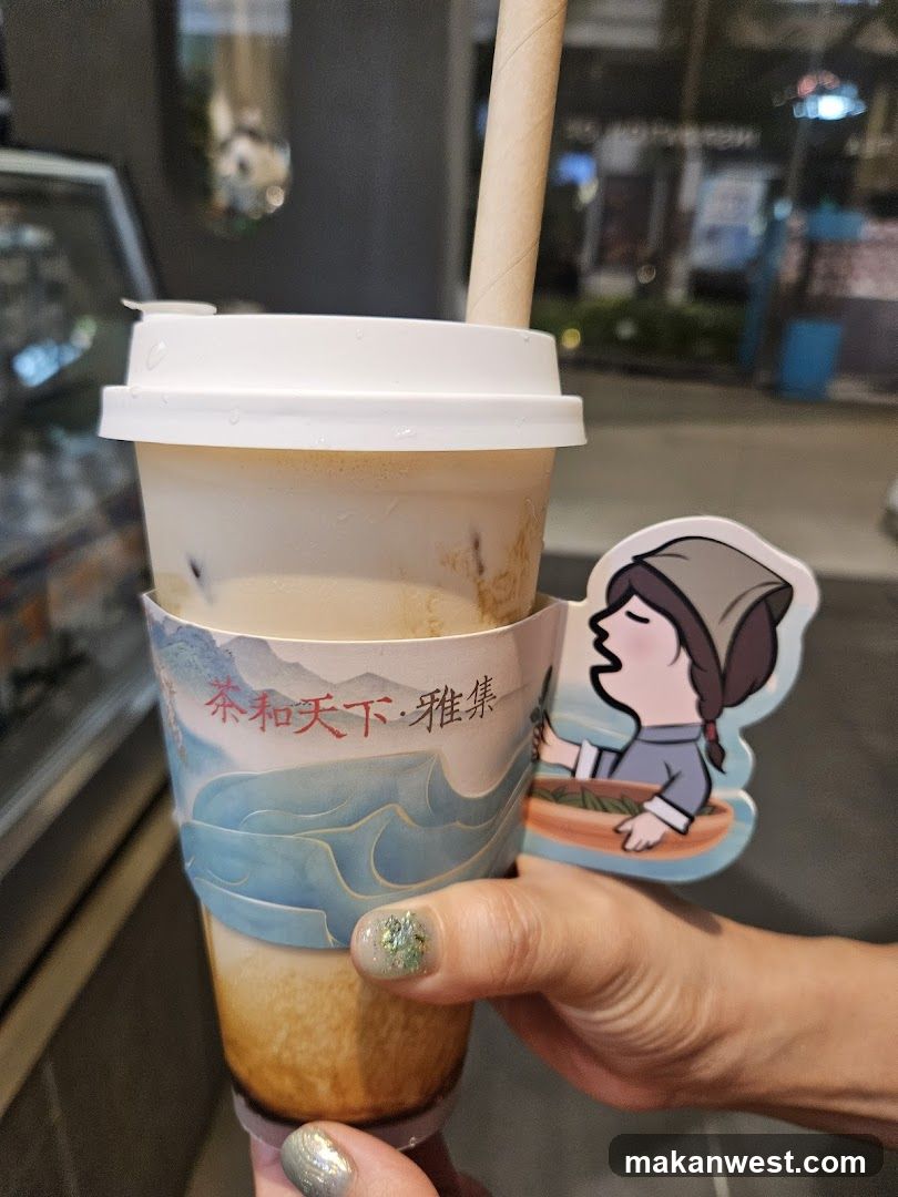 Hand holding a bubble tea with decorative sleeve