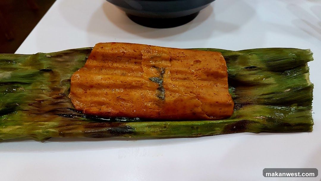 Food item wrapped in banana leaf