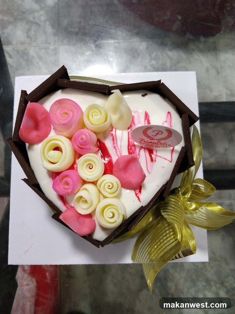 Heart-shaped cake with chocolate and frosting decorations