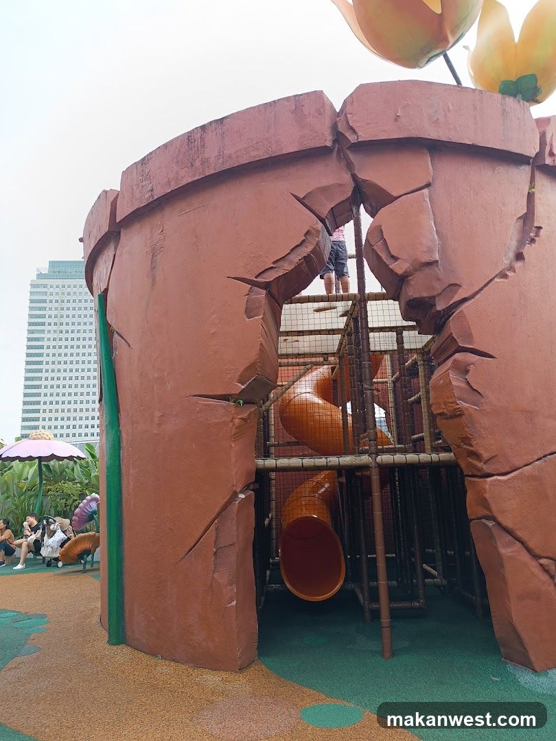 Playground structure resembling a cracked flower pot