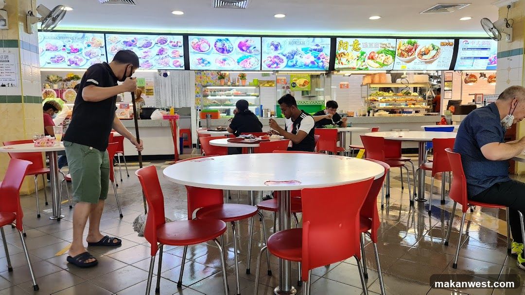 Food court interior with diners and staff