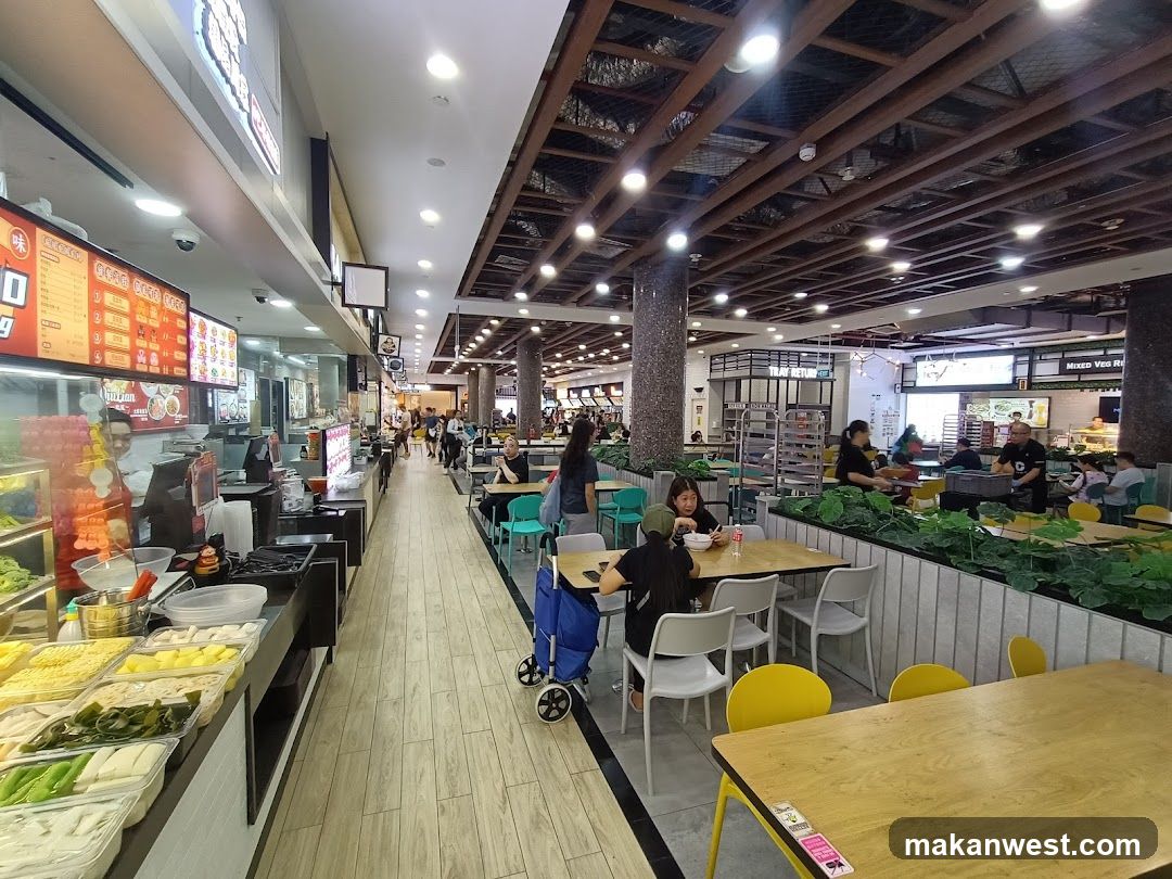 Food court with various stalls and seating areas