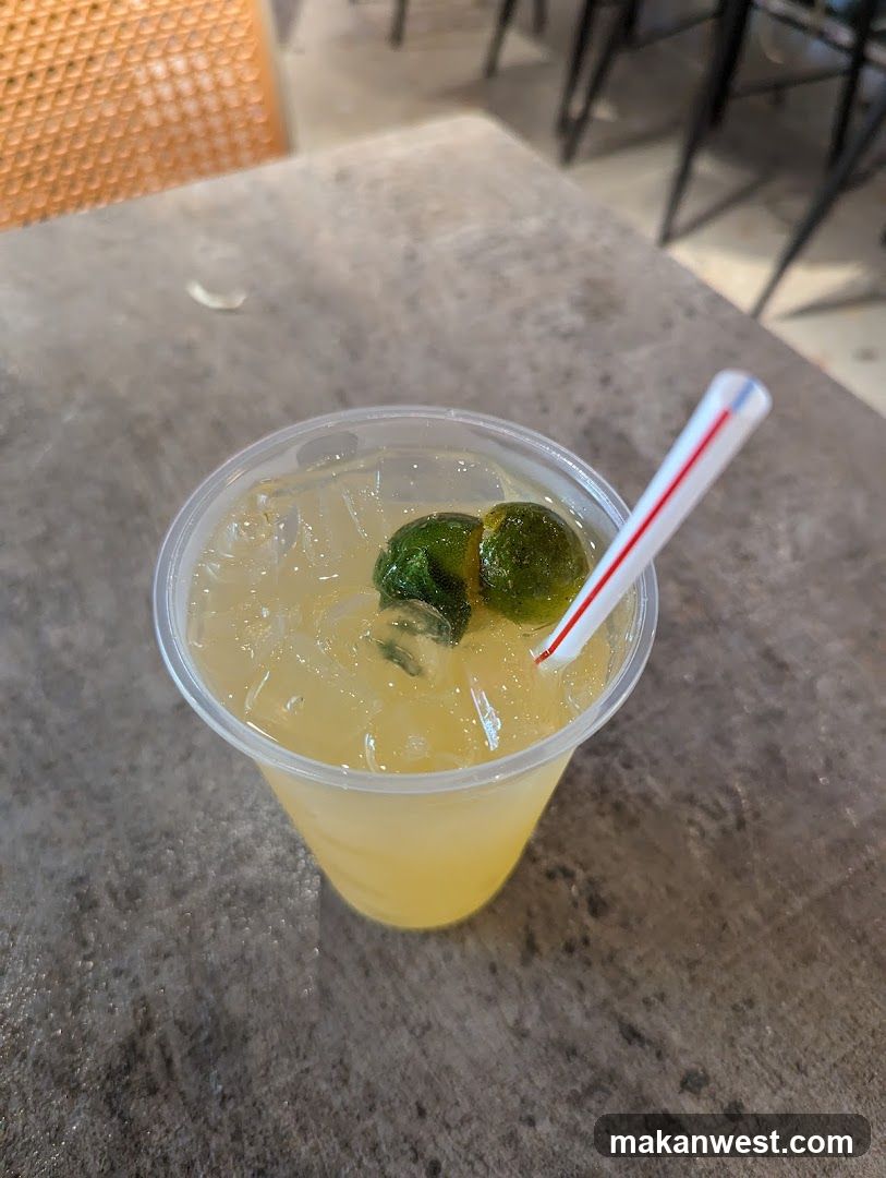 Yellow Drink with Lime and Straw