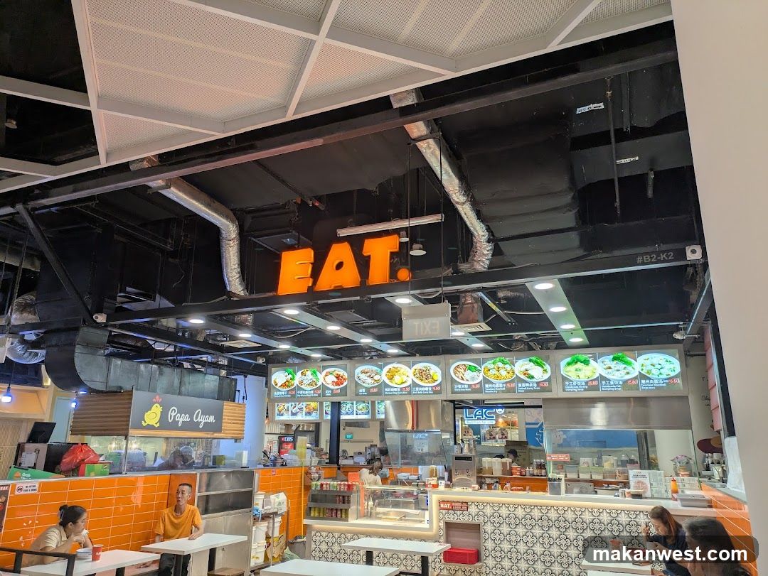 Food court with a prominent "EAT" sign