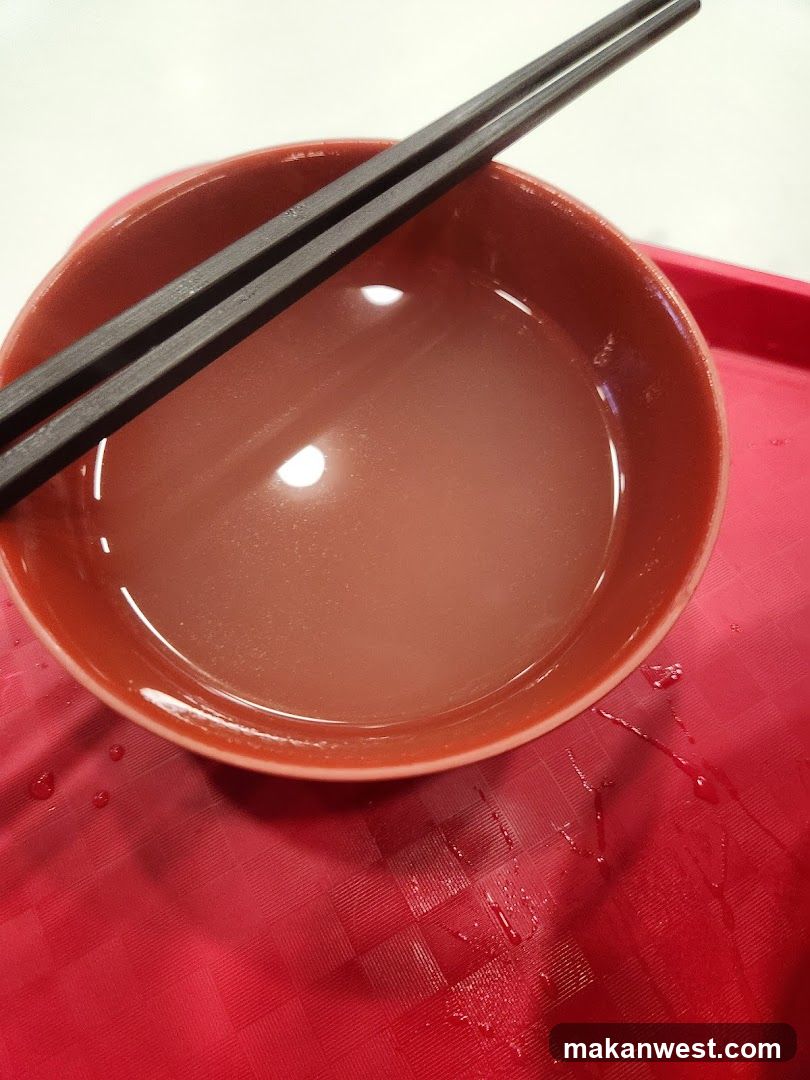 Bowl of Broth with Chopsticks