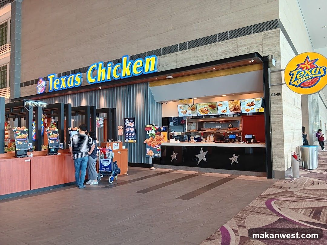 A Texas Chicken restaurant storefront with visible signage and menu boards inside the shop.