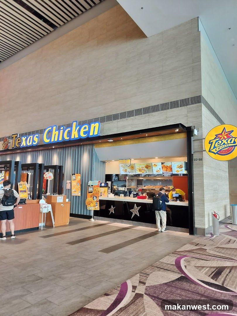 A Texas Chicken restaurant storefront with visible signage and a counter area where customers are ordering food.