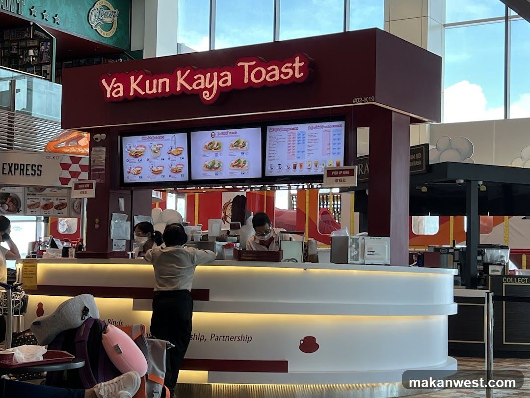 A storefront of Ya Kun Kaya Toast with visible signage and menu boards above the counter.