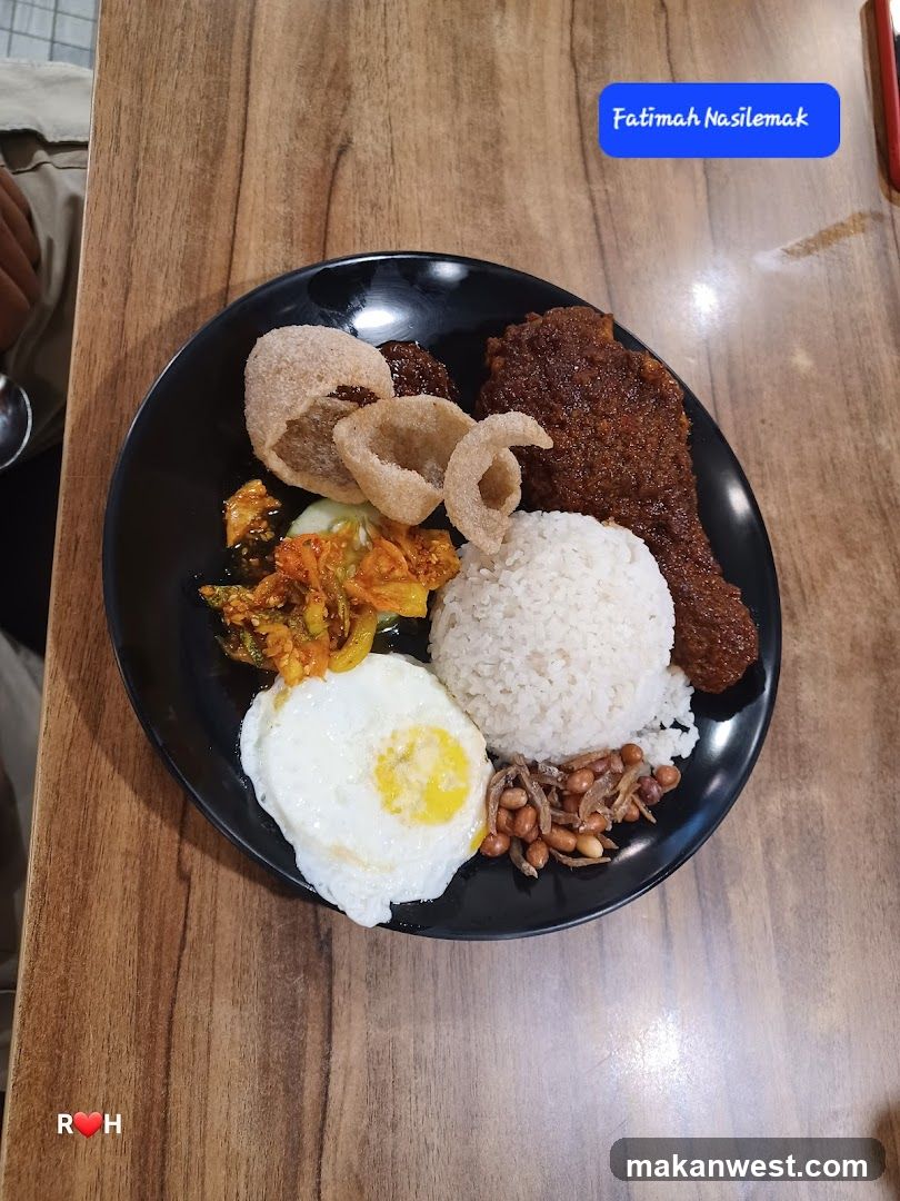 Plate of Nasi Lemak with Fried Egg and Chicken