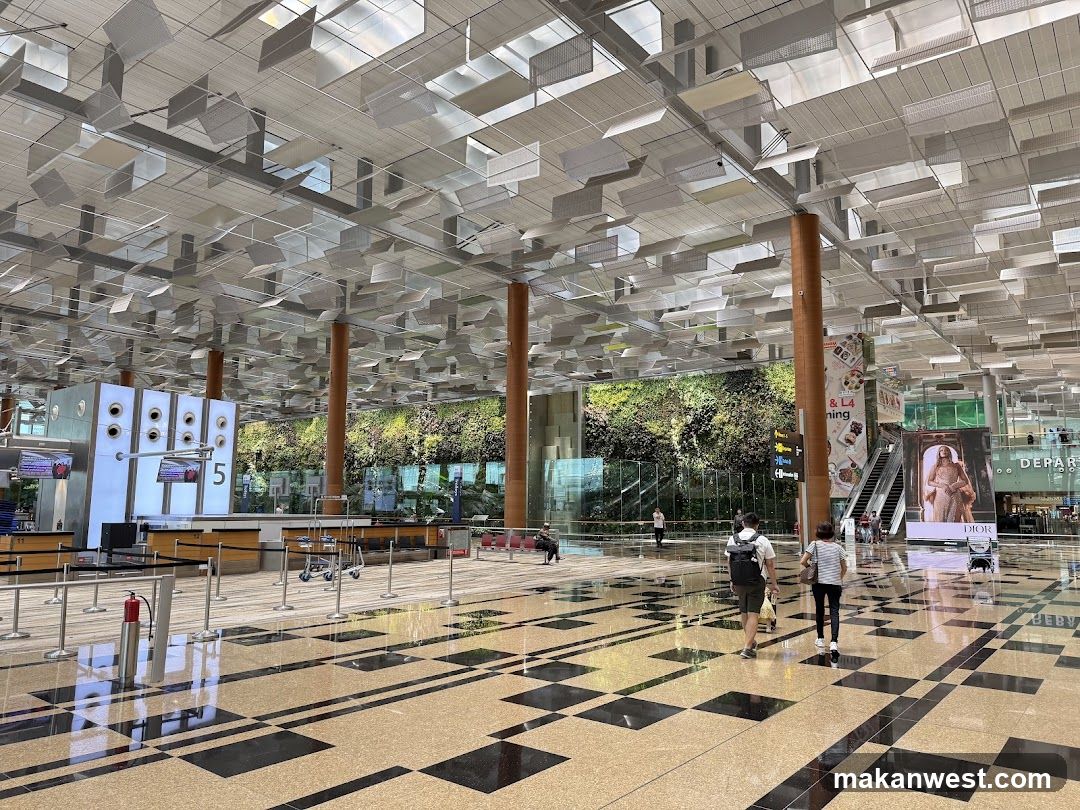 Airport Terminal Interior with Check-in Area and Green Wall
