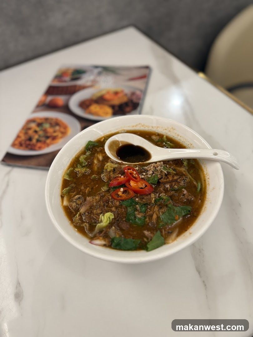 Bowl of Noodle Soup with Chili and Greens
