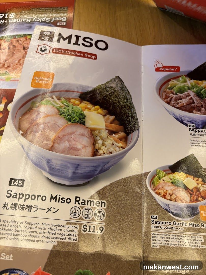 A close-up of a printed menu page featuring the Sapporo Miso Ramen dish with detailed ingredients and pricing.