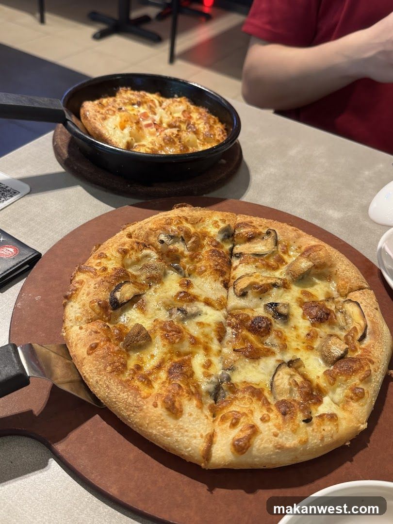 Pizza and Skillet Dish on Table