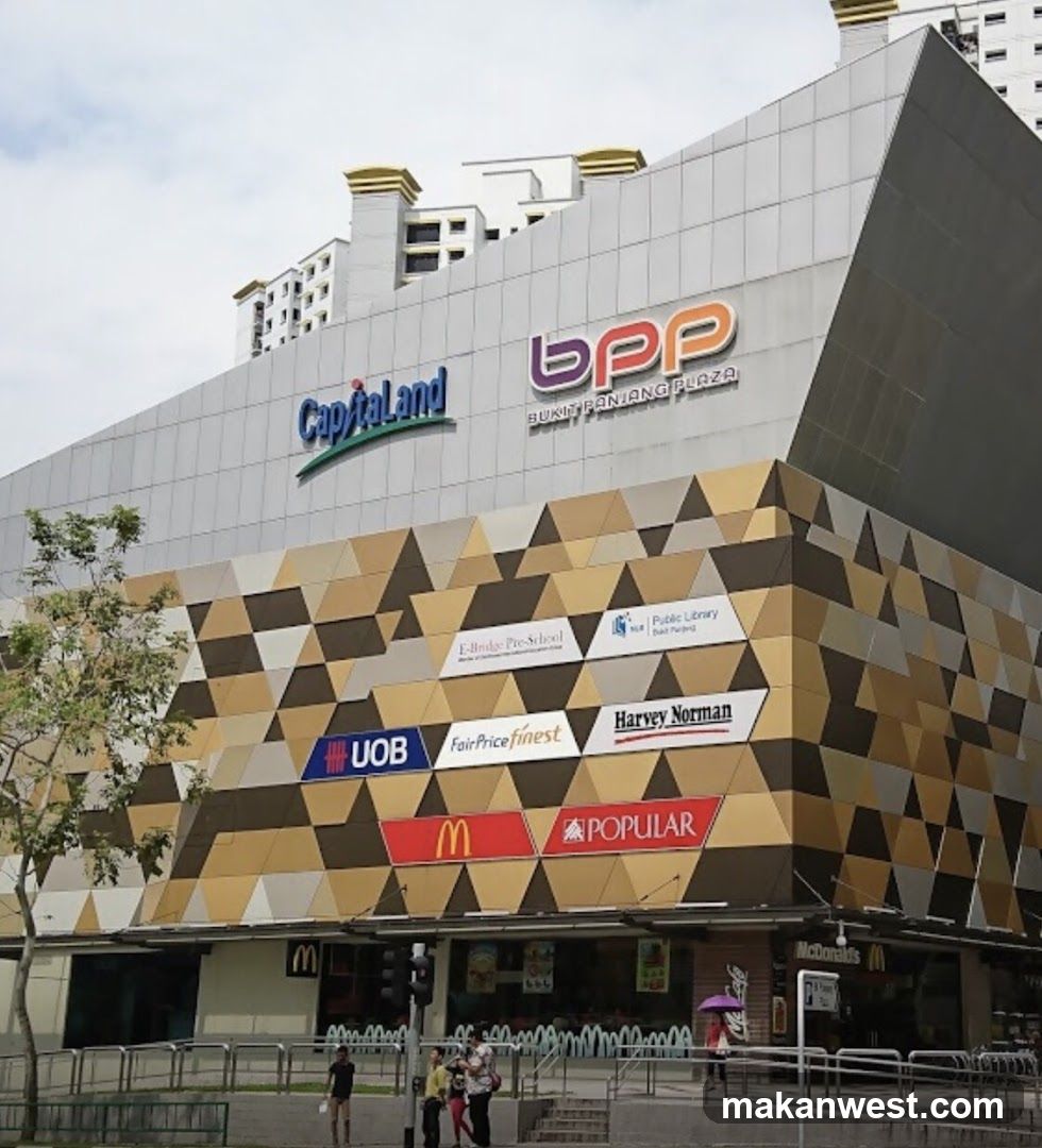 Photo of the physical exterior entrance and storefront facade of Bukit Bintang Plaza, featuring visible signage including Capitaland, BPP, UOB, FairPrice Finest, Harvey Norman, McDonald's, and Popular on the building.