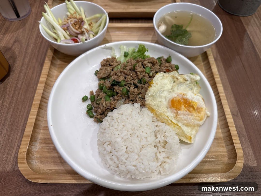 Thai-style meal with fried egg and papaya salad