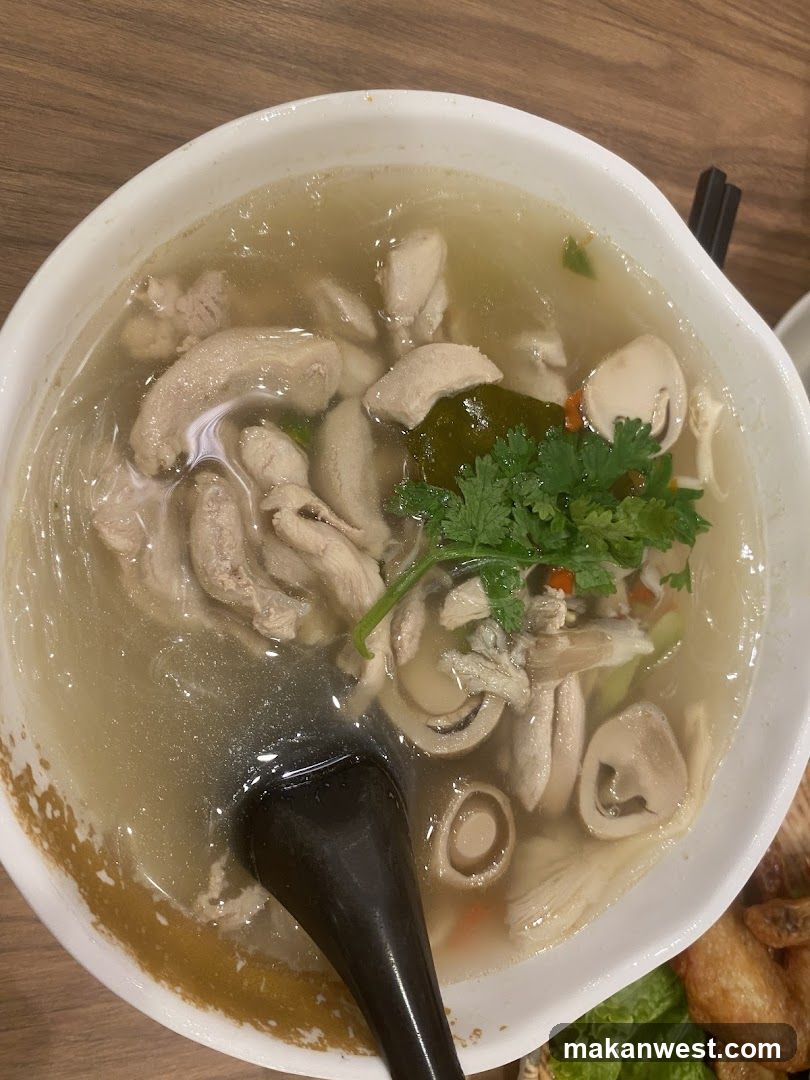 Bowl of Chicken Soup with Mushrooms and Noodles