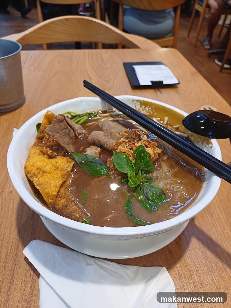 Bowl of Noodle Soup with Basil and Meat