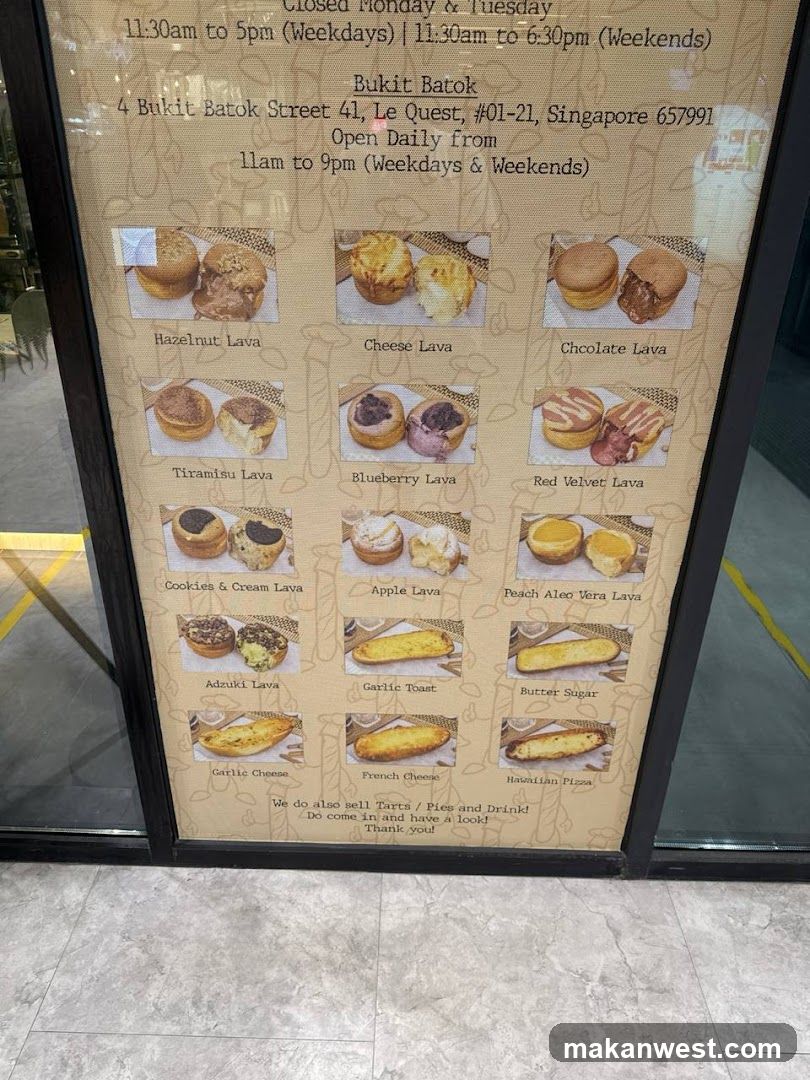 A framed menu board displaying various lava cake products with photos and names, located on a glass storefront.